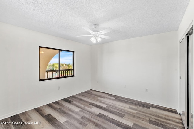 unfurnished bedroom featuring ceiling fan, a closet, light hardwood / wood-style flooring, and a textured ceiling