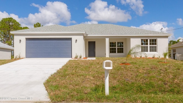 single story home with a garage and a front lawn