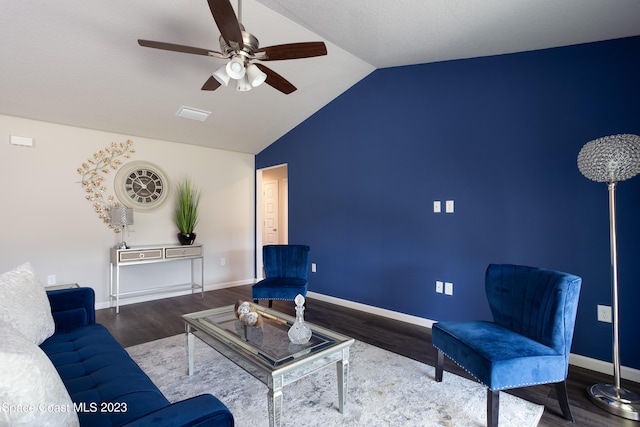 living room with ceiling fan, lofted ceiling, and dark wood-type flooring