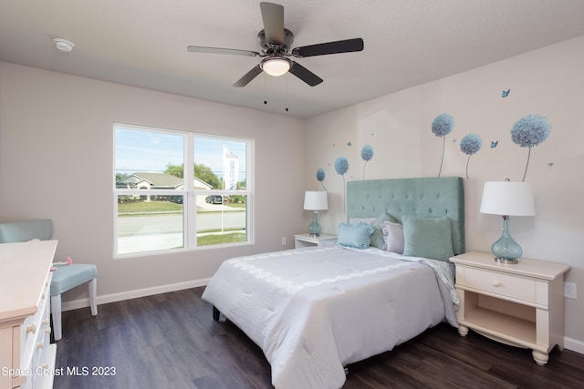 bedroom with ceiling fan and dark hardwood / wood-style flooring