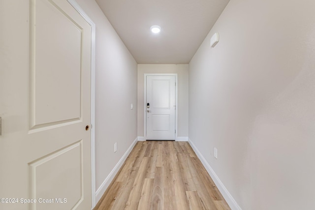 corridor with light hardwood / wood-style floors