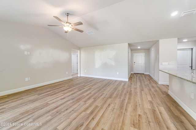 unfurnished living room with ceiling fan, light hardwood / wood-style floors, and vaulted ceiling