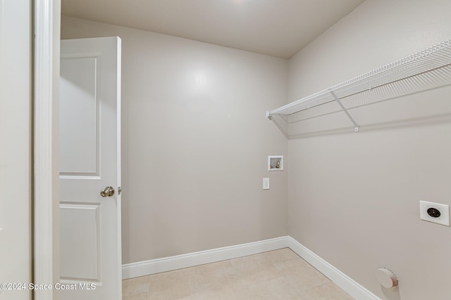 laundry room featuring hookup for a washing machine, light tile patterned floors, and hookup for an electric dryer