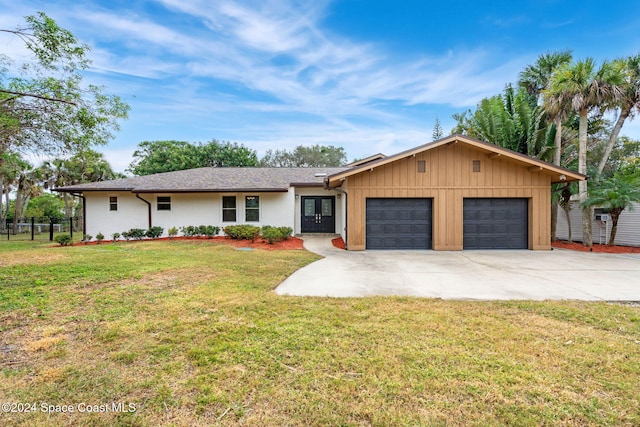 ranch-style home featuring a front yard and a garage