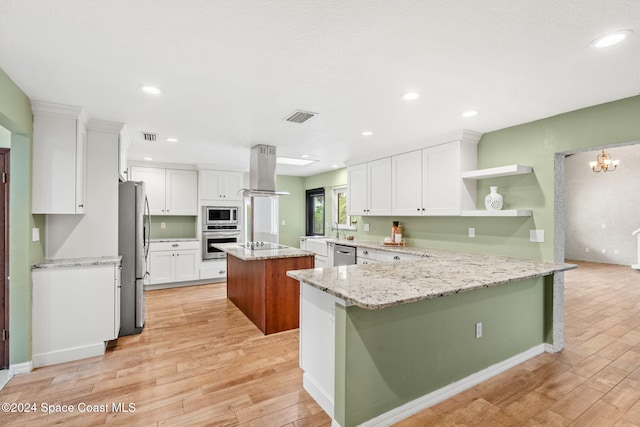 kitchen featuring white cabinetry, light hardwood / wood-style flooring, island range hood, and appliances with stainless steel finishes