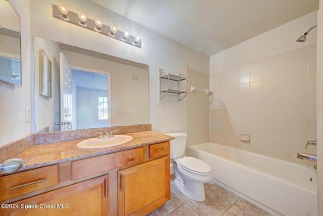 full bathroom featuring tile patterned floors, vanity, toilet, and tiled shower / bath