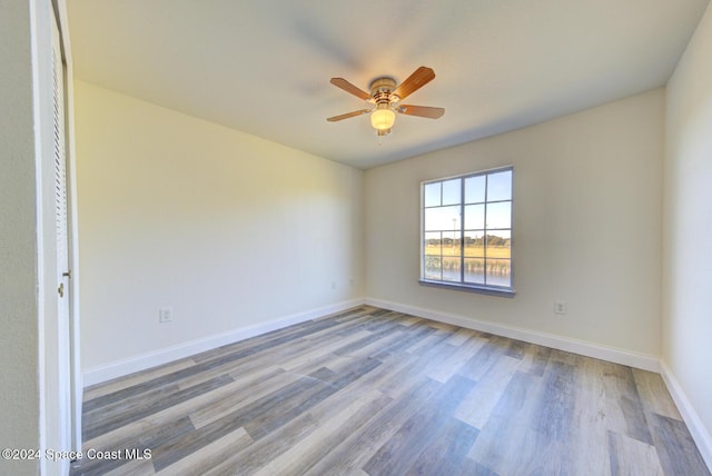 empty room featuring hardwood / wood-style floors and ceiling fan