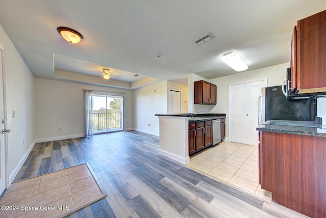 kitchen featuring light hardwood / wood-style flooring, a textured ceiling, and appliances with stainless steel finishes