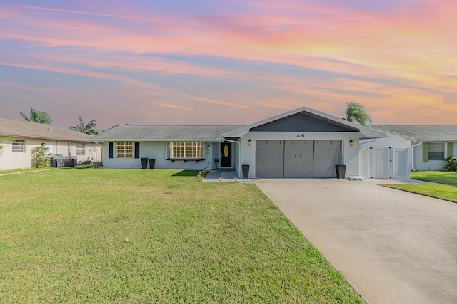 ranch-style home with a lawn and a garage