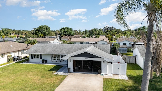 view of front facade with a garage, a front yard, and central AC