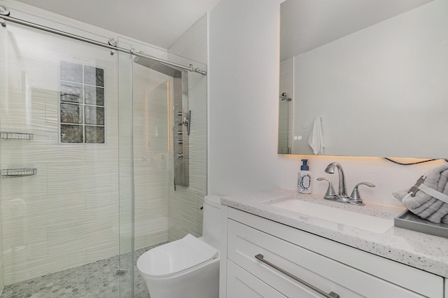 bathroom with vanity, an enclosed shower, and toilet