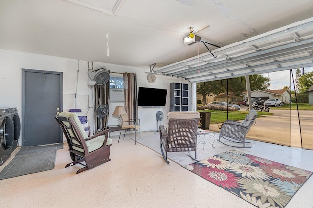 garage with independent washer and dryer and a garage door opener