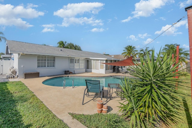 view of pool featuring a sunroom and a patio area