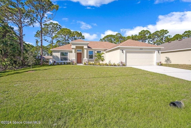 view of front of property featuring a garage and a front lawn