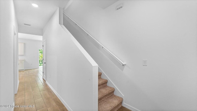 stairs with hardwood / wood-style flooring