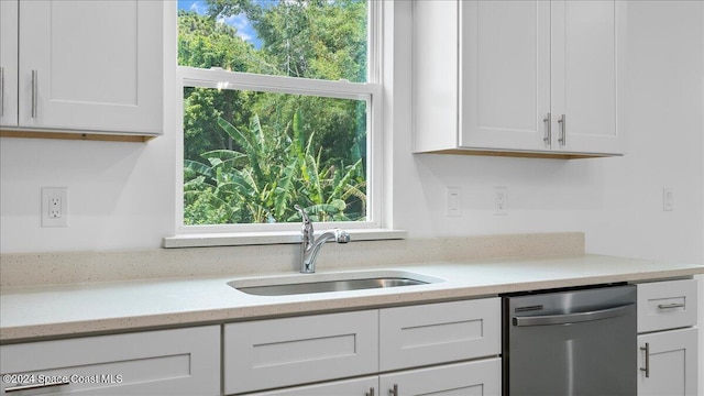 kitchen with sink, white cabinets, and stainless steel dishwasher