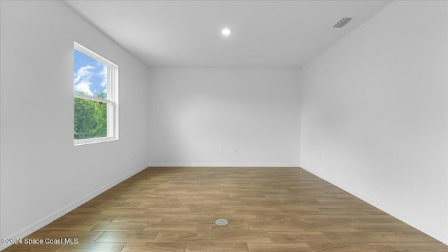 empty room with light hardwood / wood-style flooring