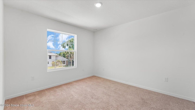 unfurnished room with light carpet