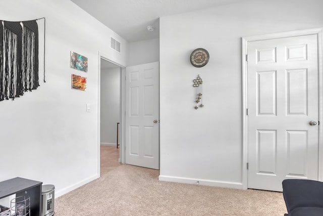 interior space featuring light carpet