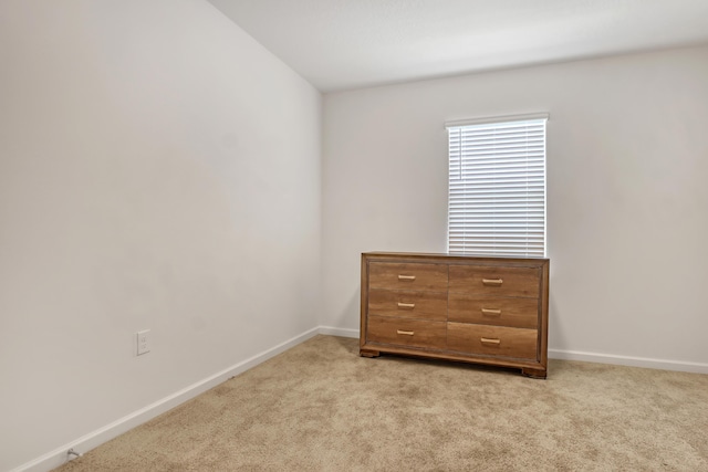 unfurnished bedroom featuring light carpet