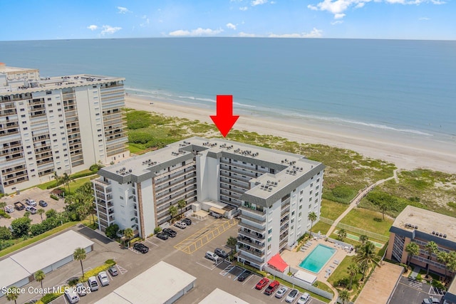 drone / aerial view featuring a water view and a view of the beach