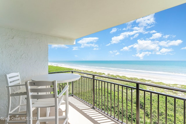 balcony with a view of the beach and a water view