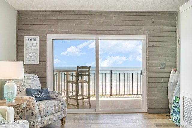 650 N Atlantic Ave # 706, Cocoa Beach, FL 32931 - living area featuring wooden walls, wood finished floors, and a water view