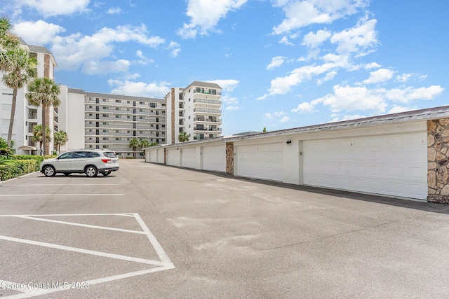 650 N Atlantic Ave # 706, Cocoa Beach, FL 32931 - uncovered parking lot with community garages
