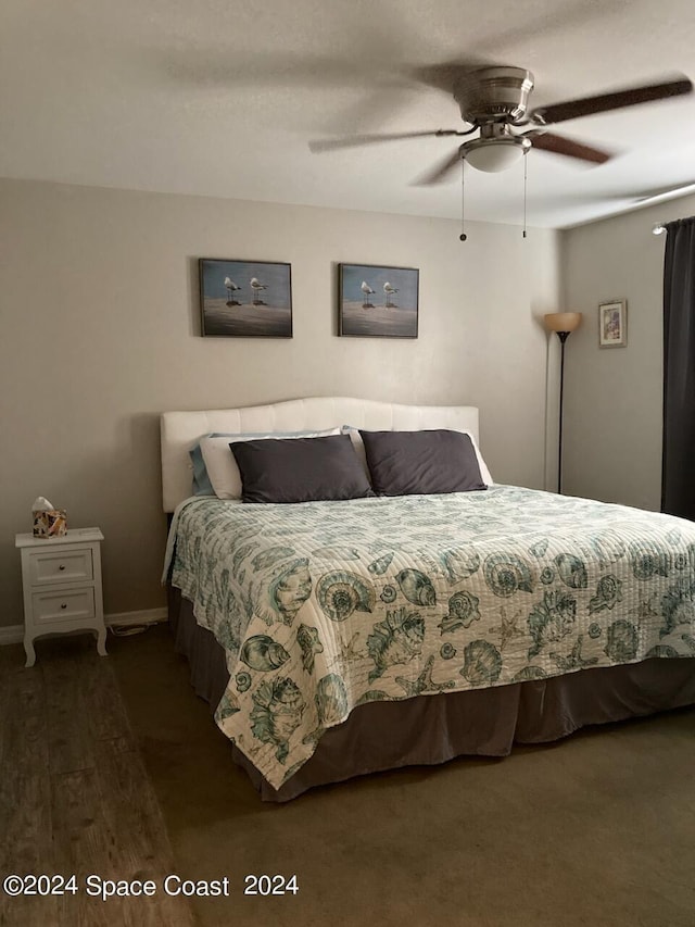 bedroom featuring ceiling fan and dark hardwood / wood-style floors