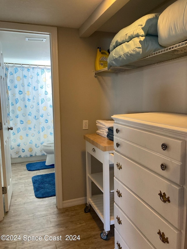 spacious closet with light hardwood / wood-style floors