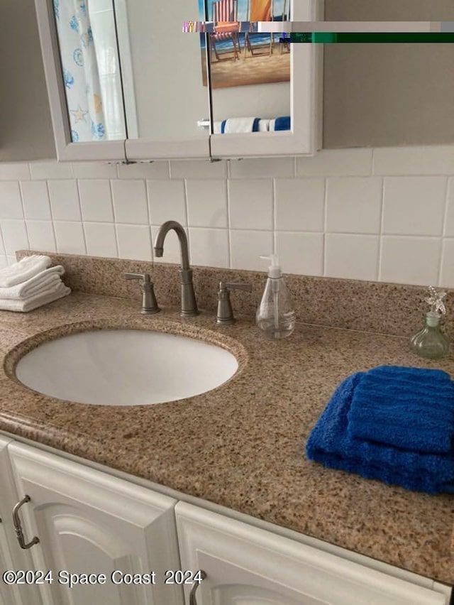 interior details featuring decorative backsplash and vanity