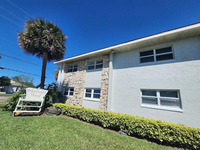 view of property exterior featuring a lawn