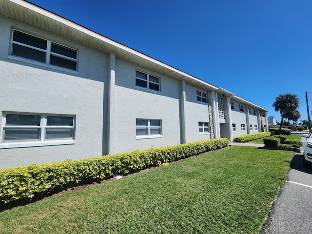 view of property exterior with a yard