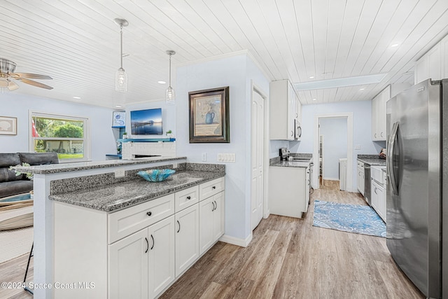 kitchen with appliances with stainless steel finishes, a kitchen breakfast bar, wooden ceiling, white cabinets, and light hardwood / wood-style floors