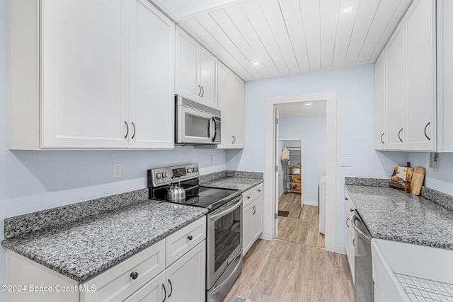 kitchen with light stone countertops, light wood-type flooring, wood ceiling, stainless steel appliances, and white cabinetry