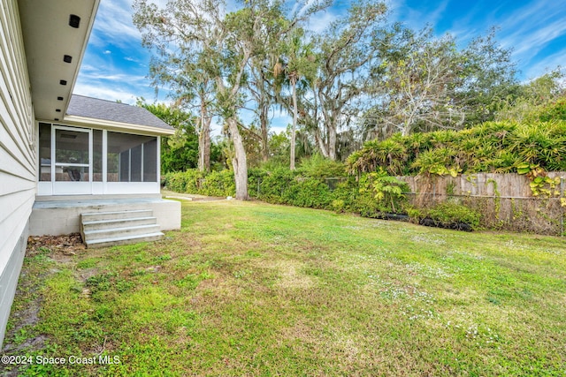 view of yard with a sunroom