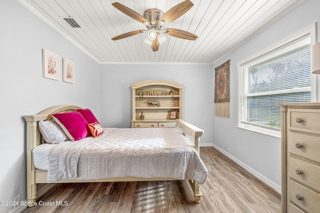 bedroom with ornamental molding, light hardwood / wood-style flooring, ceiling fan, and wooden ceiling