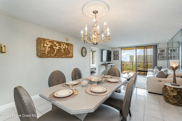 dining space with light tile patterned floors, a textured ceiling, an inviting chandelier, and a wall of windows