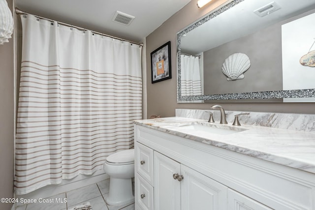 full bathroom with tile patterned floors, shower / bath combo with shower curtain, vanity, and toilet