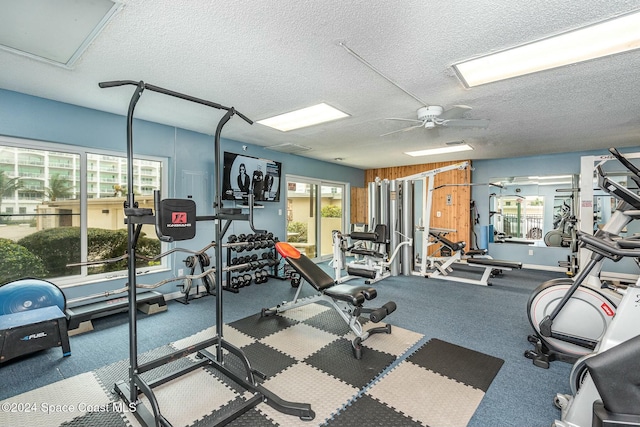 workout area featuring a textured ceiling and ceiling fan