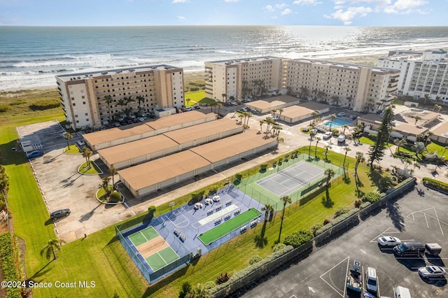 birds eye view of property featuring a water view and a beach view