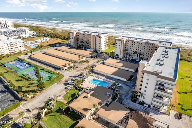 birds eye view of property featuring a water view and a beach view