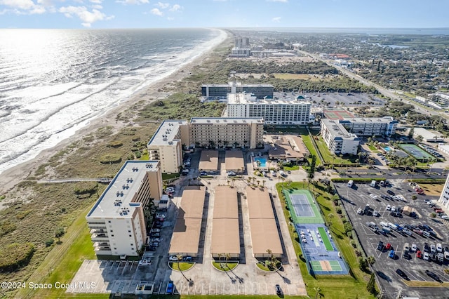 drone / aerial view with a water view and a view of the beach