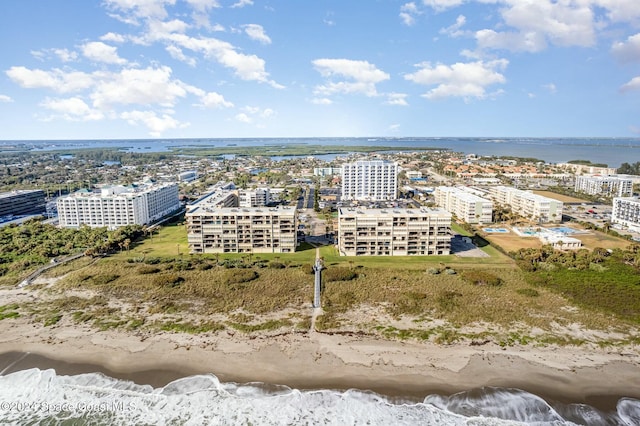 birds eye view of property with a water view and a view of the beach