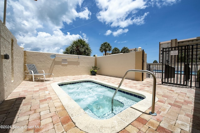 view of swimming pool with a community hot tub