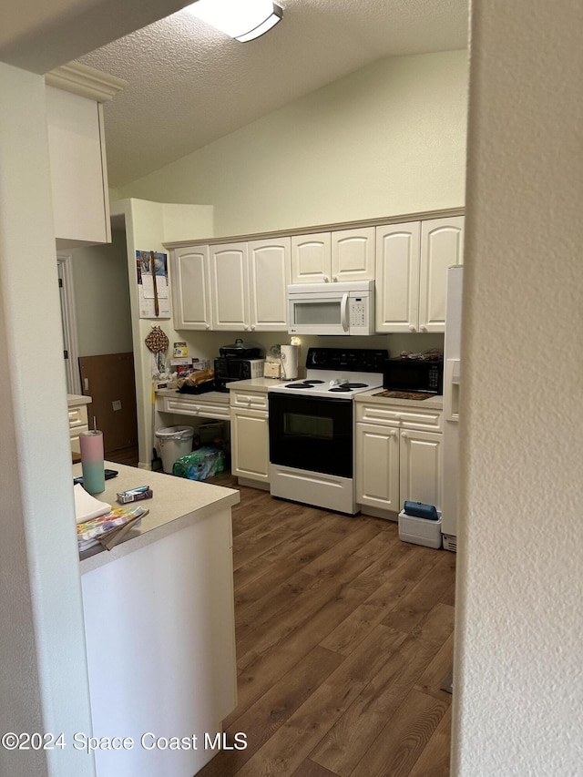 kitchen featuring vaulted ceiling, white cabinets, white appliances, a textured ceiling, and dark hardwood / wood-style floors