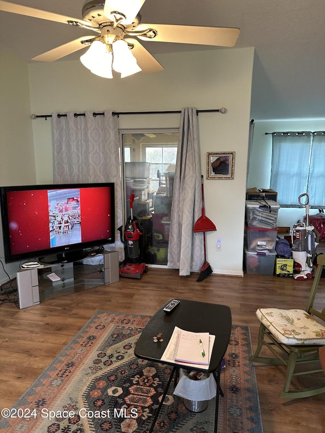 living room with hardwood / wood-style flooring and ceiling fan