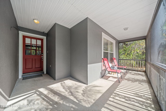 entrance to property featuring covered porch