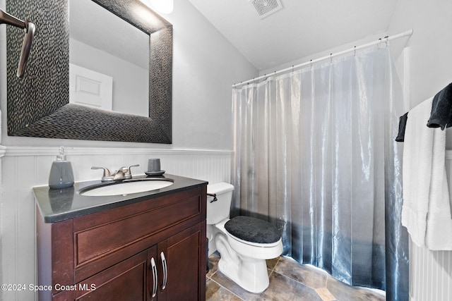 bathroom featuring vanity, curtained shower, and toilet