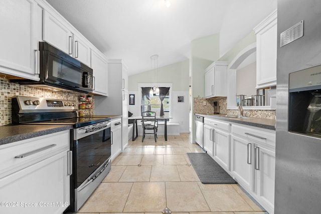 kitchen with white cabinetry, stainless steel appliances, backsplash, vaulted ceiling, and light tile patterned floors